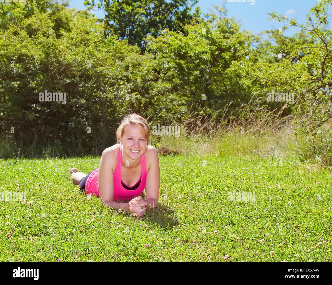 young woman lying on green grass Stock Photo - Alamy
