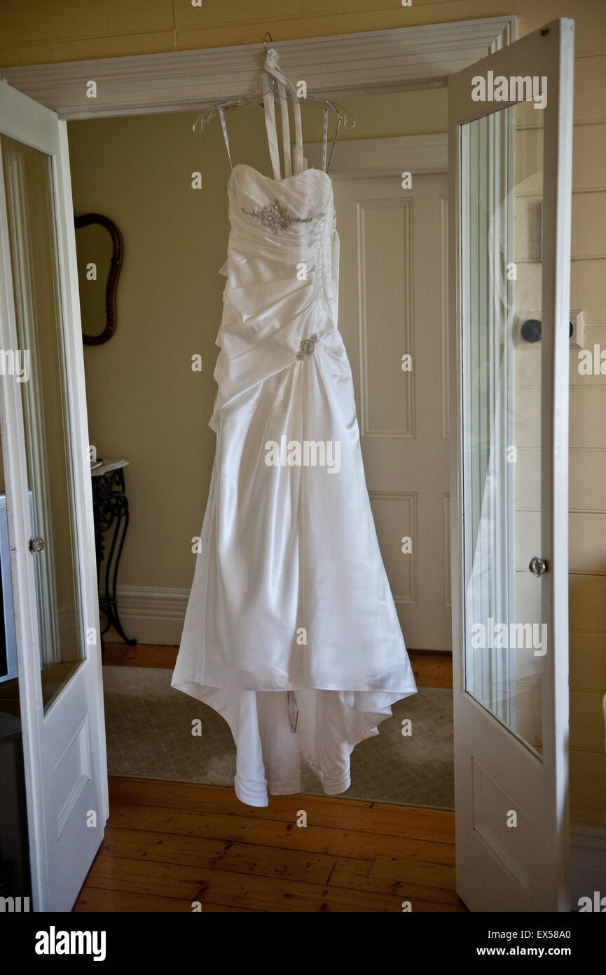 Wedding dress hanging ready for the bride to put on Stock Photo - Alamy