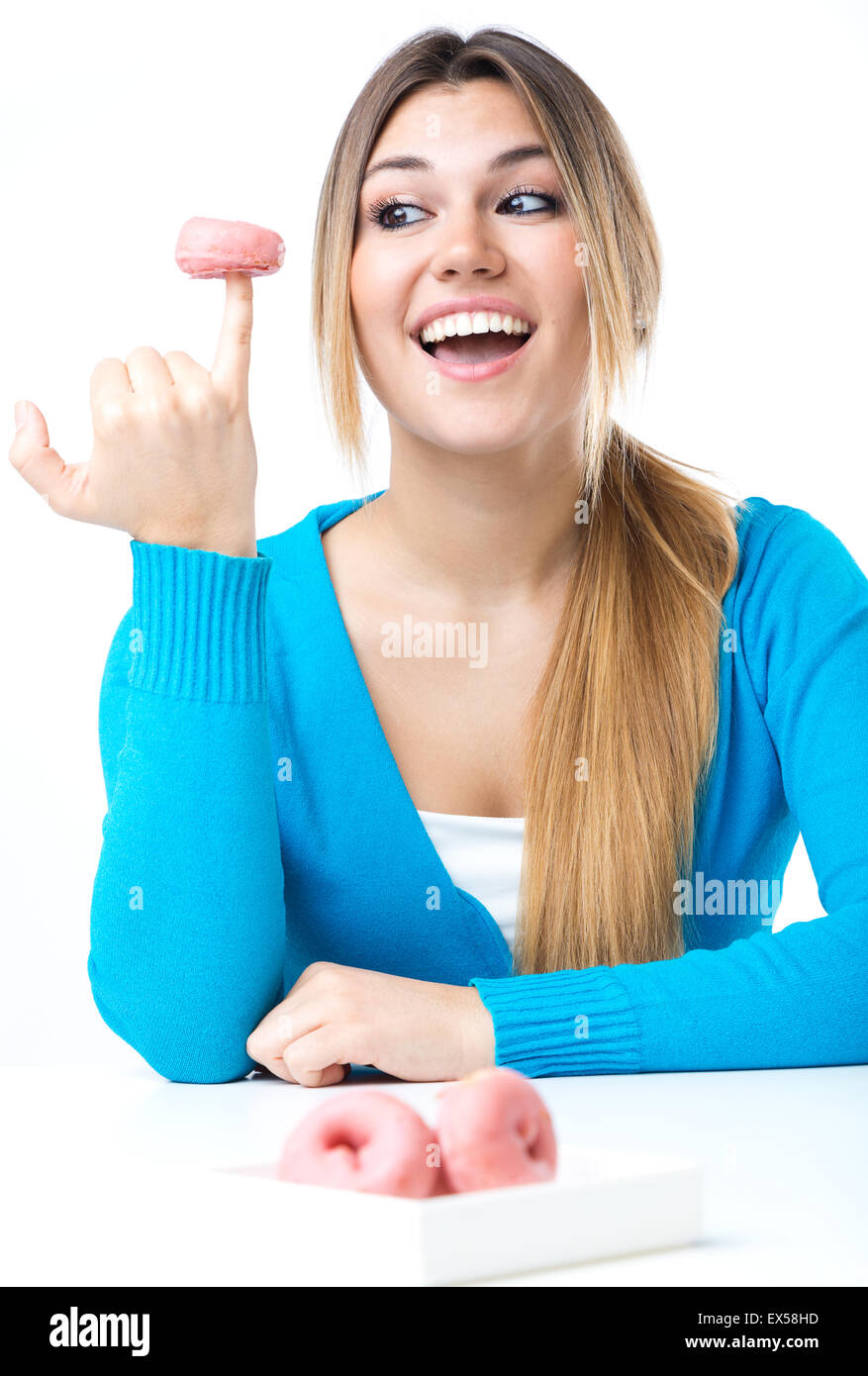 Portrait of young beautiful girl eating donut. Isolated on white. Stock Photo