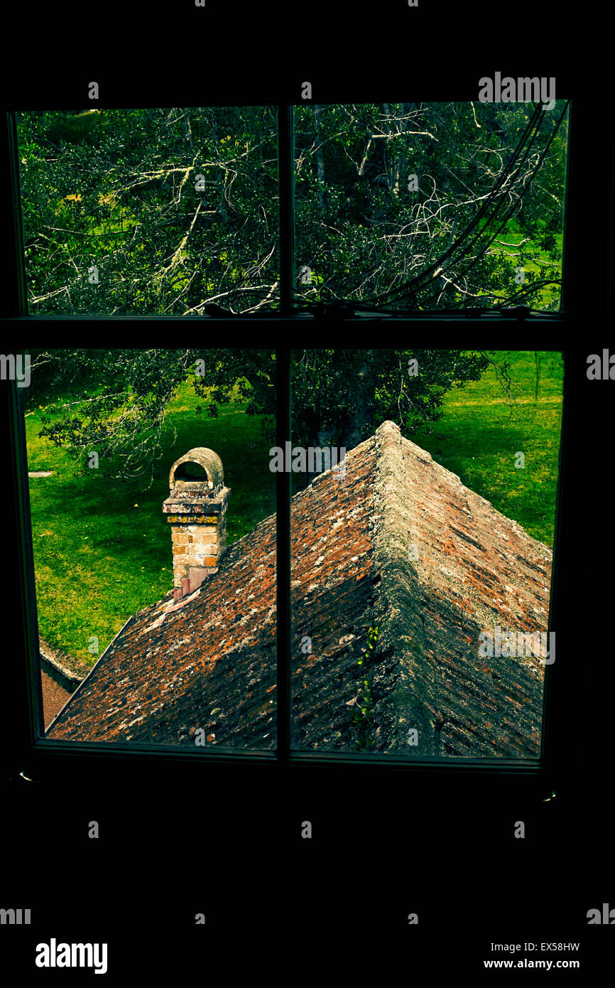 View through the upstairs window over a tiled roof in Huia Lodge, Cromwell Park, Auckland, New Zealand. treated in a retro style Stock Photo