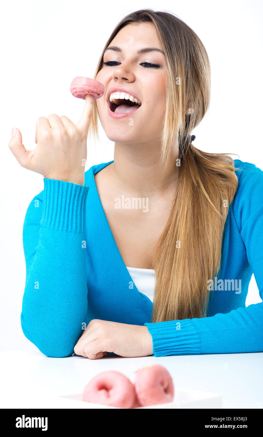 Portrait of young beautiful girl eating donut. Isolated on white. Stock Photo