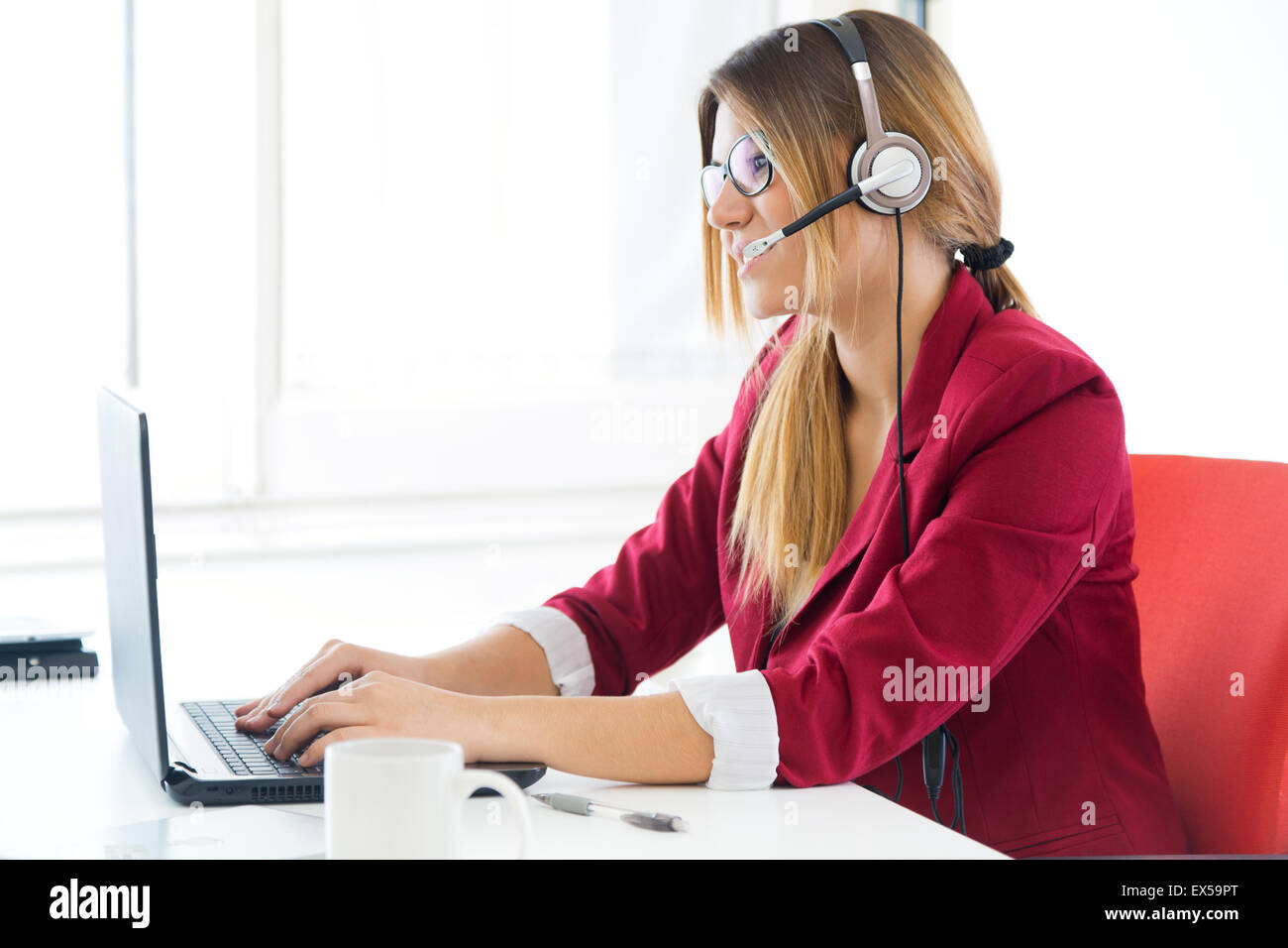 Portrait of young business girl using her computer. Stock Photo