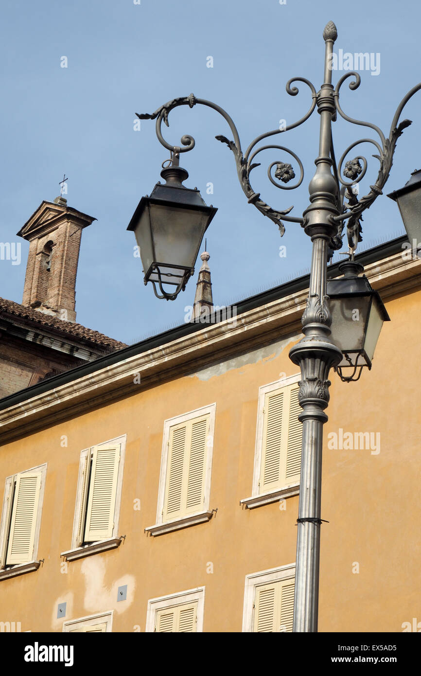 Ornate lamp post and lights and apartment building. Stock Photo