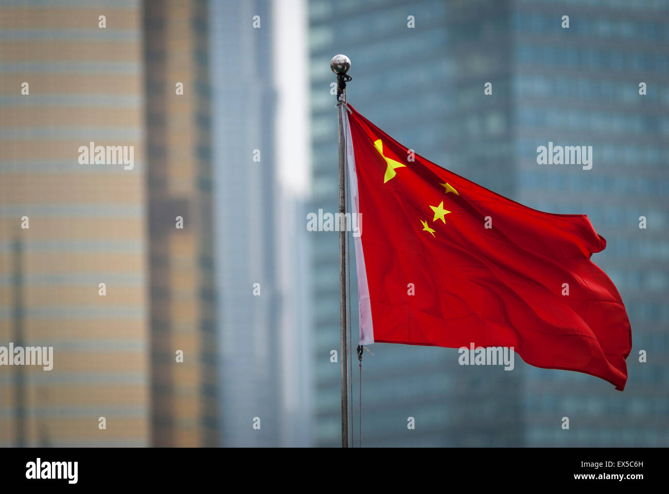 Chinese flag in Shanghai with modern buildings in the background Stock Photo