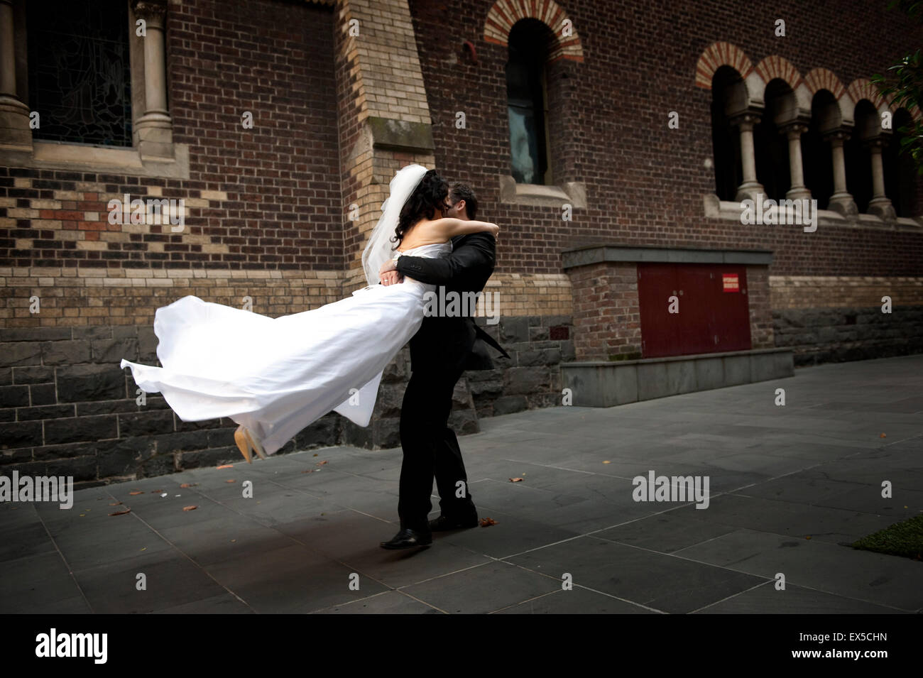 Groom twirling bride around Stock Photo