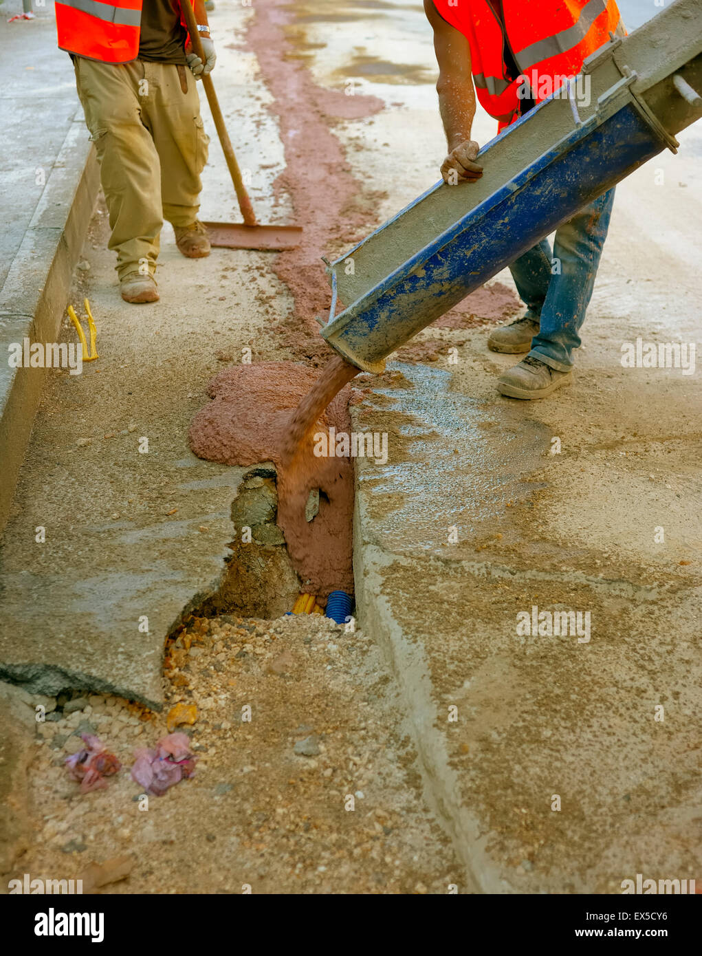 fiber optic cables buried in a micro trench with concrete colored red