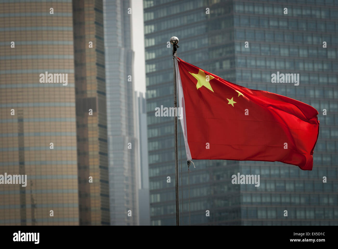Chinese flag in Shanghai with modern buildings in the background Stock Photo
