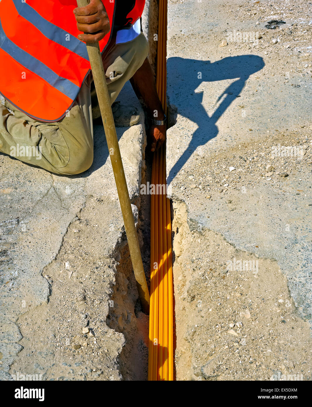 fiber optic cables buried in a micro trench by a worker Stock Photo Alamy