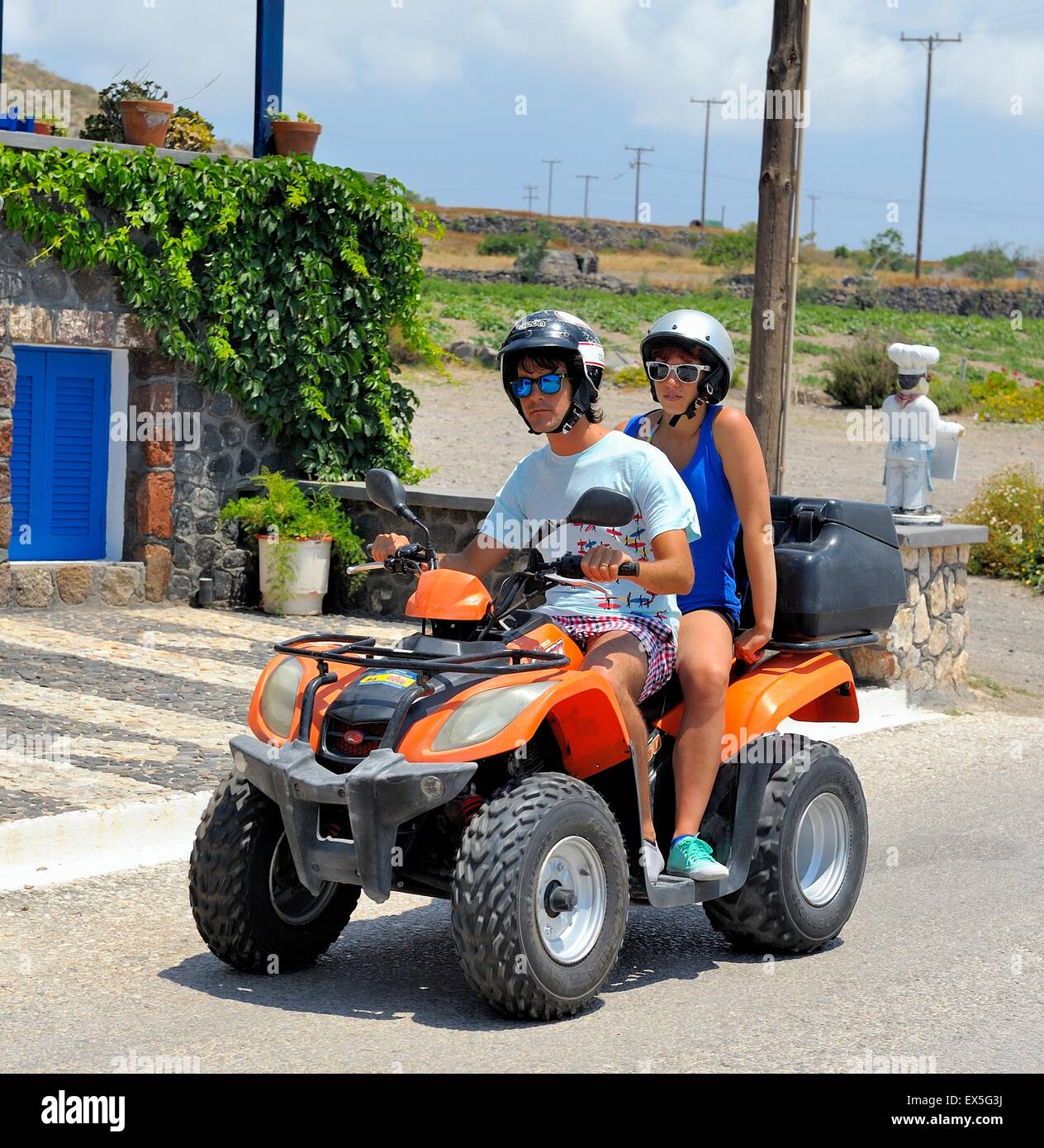 A young couple riding an ATV quad rental bike in Akrotiri Santorini Greece  Stock Photo - Alamy