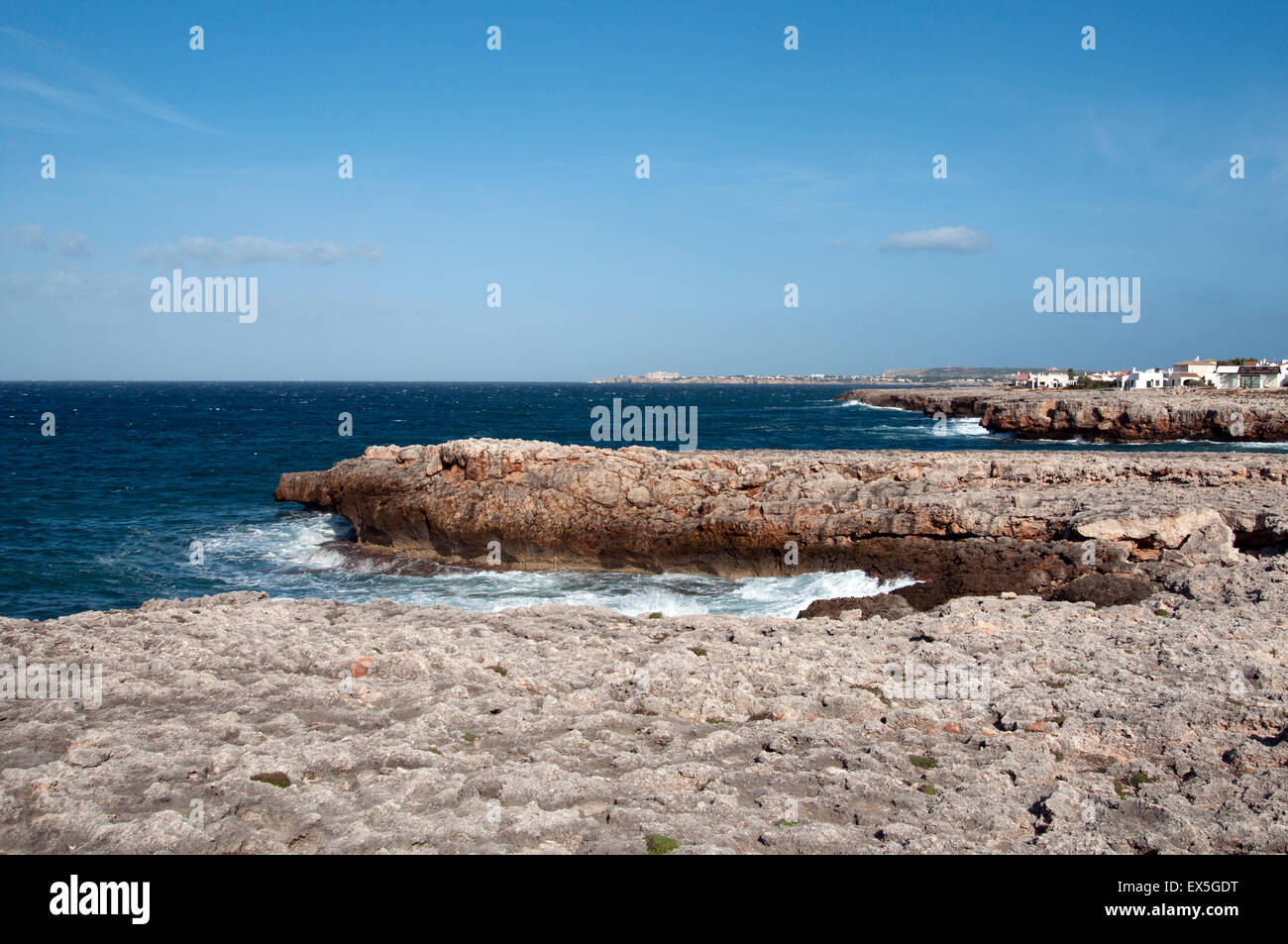 The coastal rocks and deep blue sea to the south of Ciutadella on the ...