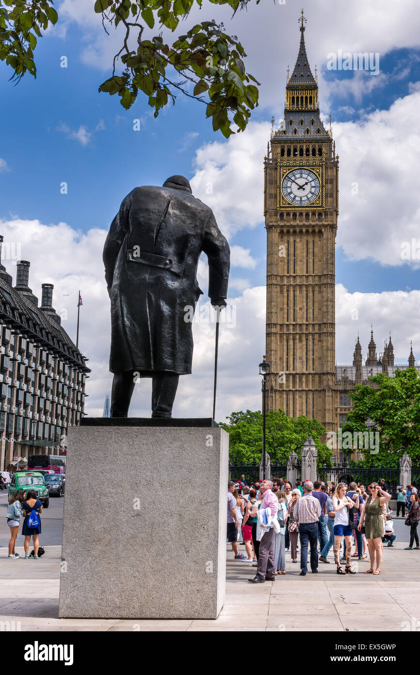 The statue of Sir Winston Churchill facing towards the  Elizabeth Tower which houses the world famous bell Big Ben. Stock Photo