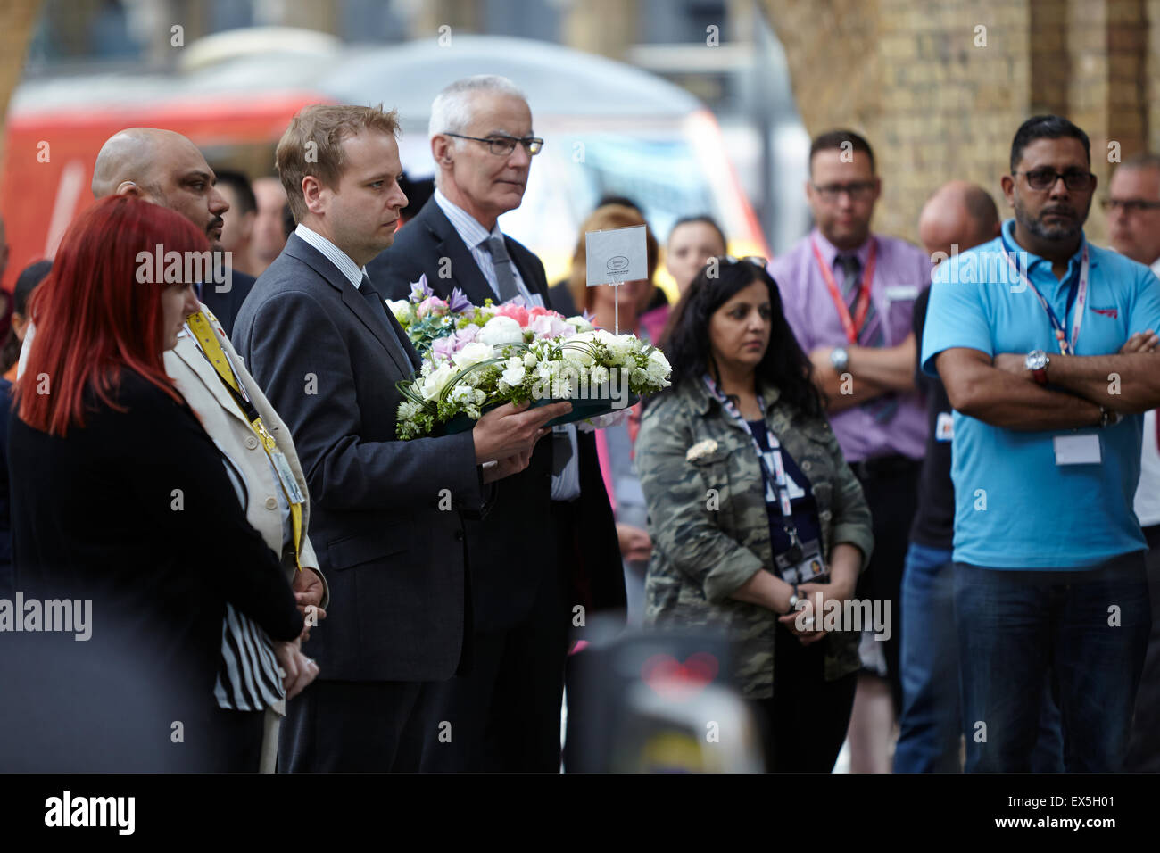 London, UK. 7th July, 2015. During a minutes silence, London Underground Staff lay wreaths at King's Cross Underground Station.  It is 10 years ago today since the underground was bombed by terrorists.  King's Cross Station, London, UK.  July 7th, 2015. Credit:  Sam Barnes/Alamy Live News Stock Photo