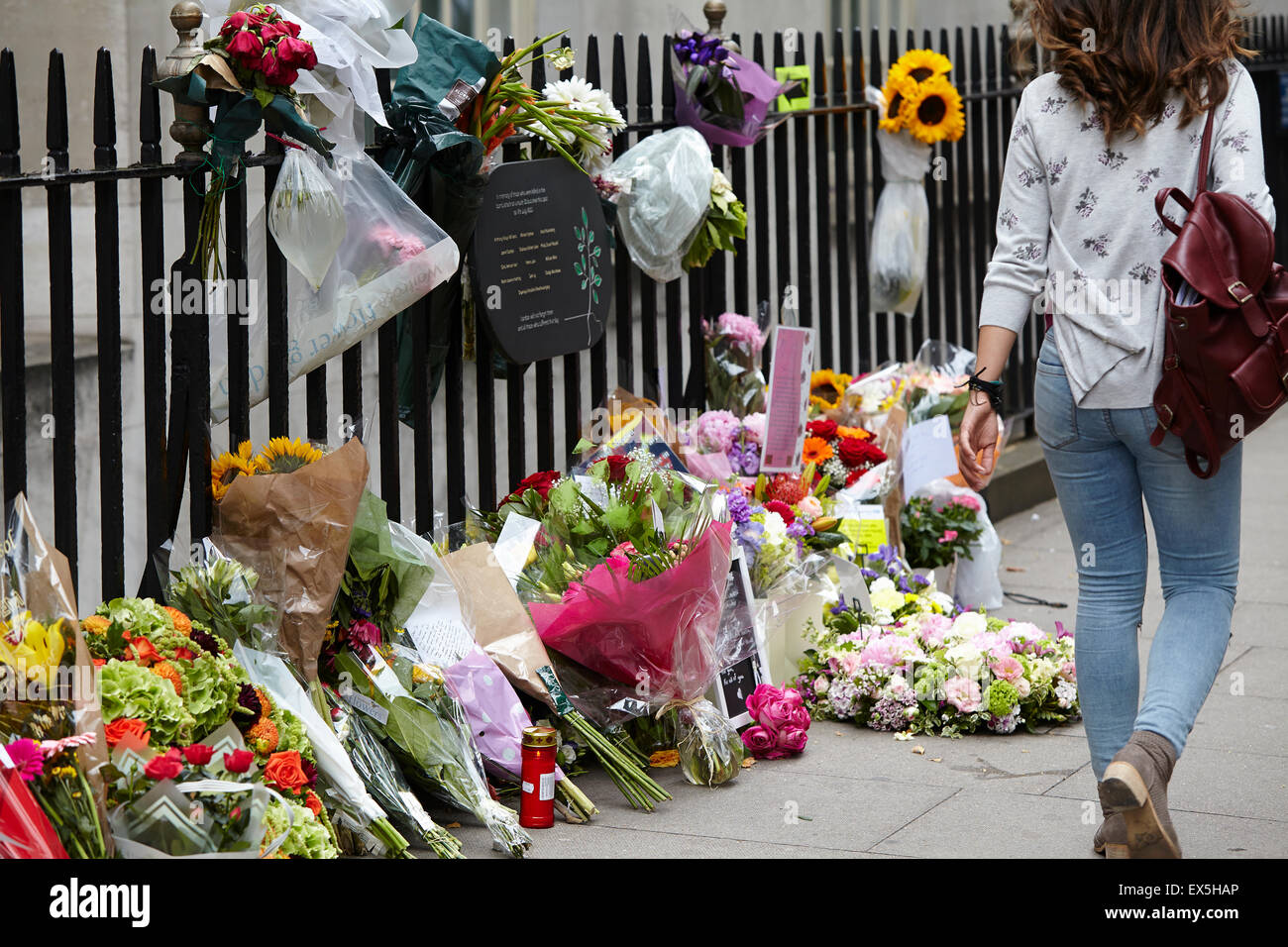 London, UK. 7th July, 2015. Passers by read messages and tributes to the victims of the final 7/7 bomber.  One man, perhaps a friend or relative, broke down in tears. Tavistock Square, London, UK.  07th July 2015. Credit:  Sam Barnes/Alamy Live News Stock Photo