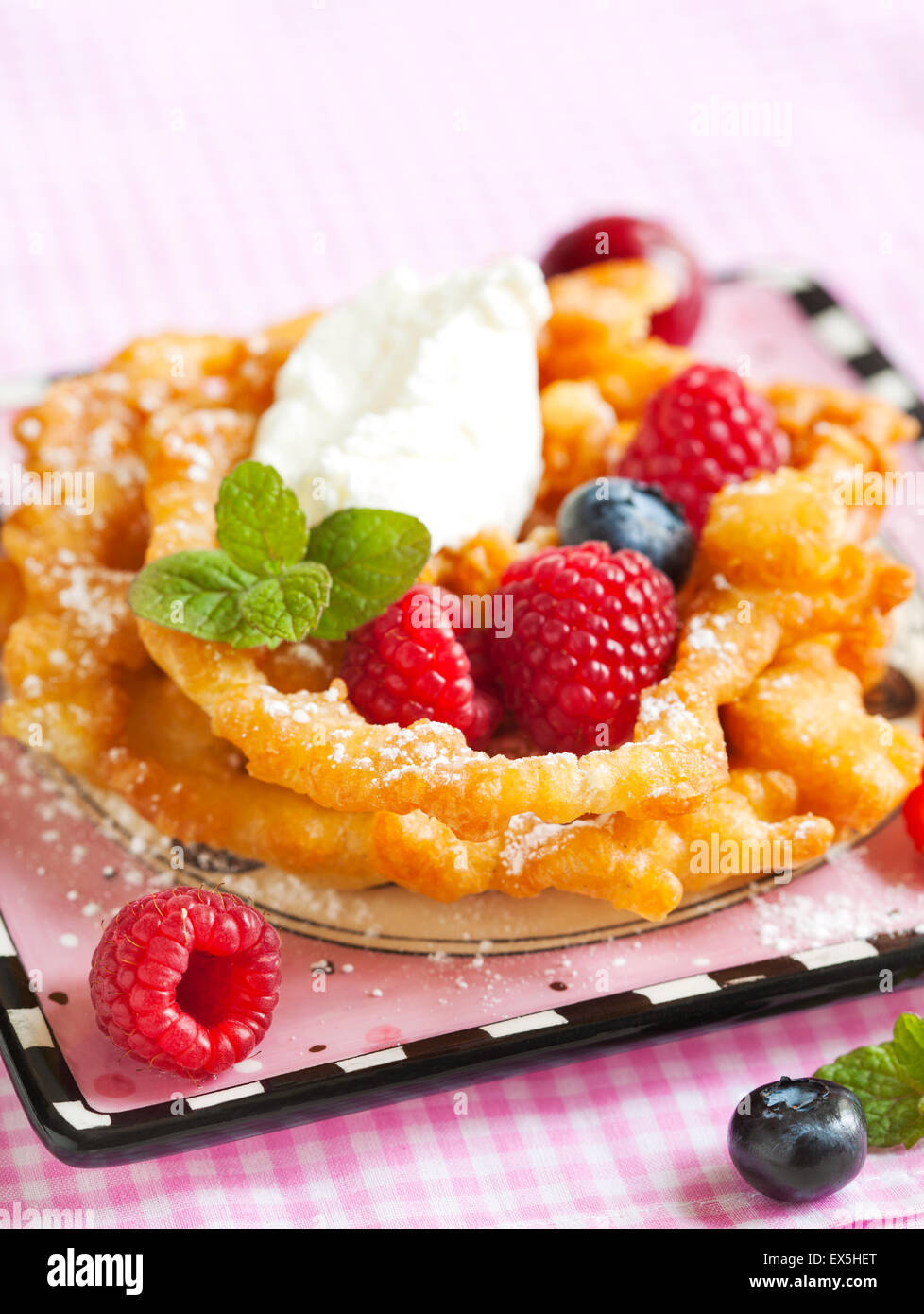 Funnel cakes with fresh berries and whipped cream Stock Photo