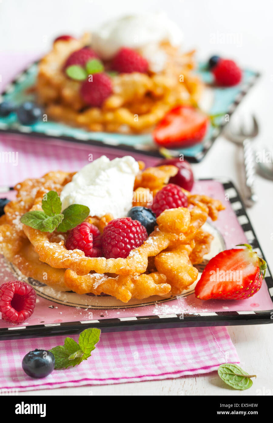 Funnel cakes with fresh berries and whipped cream Stock Photo