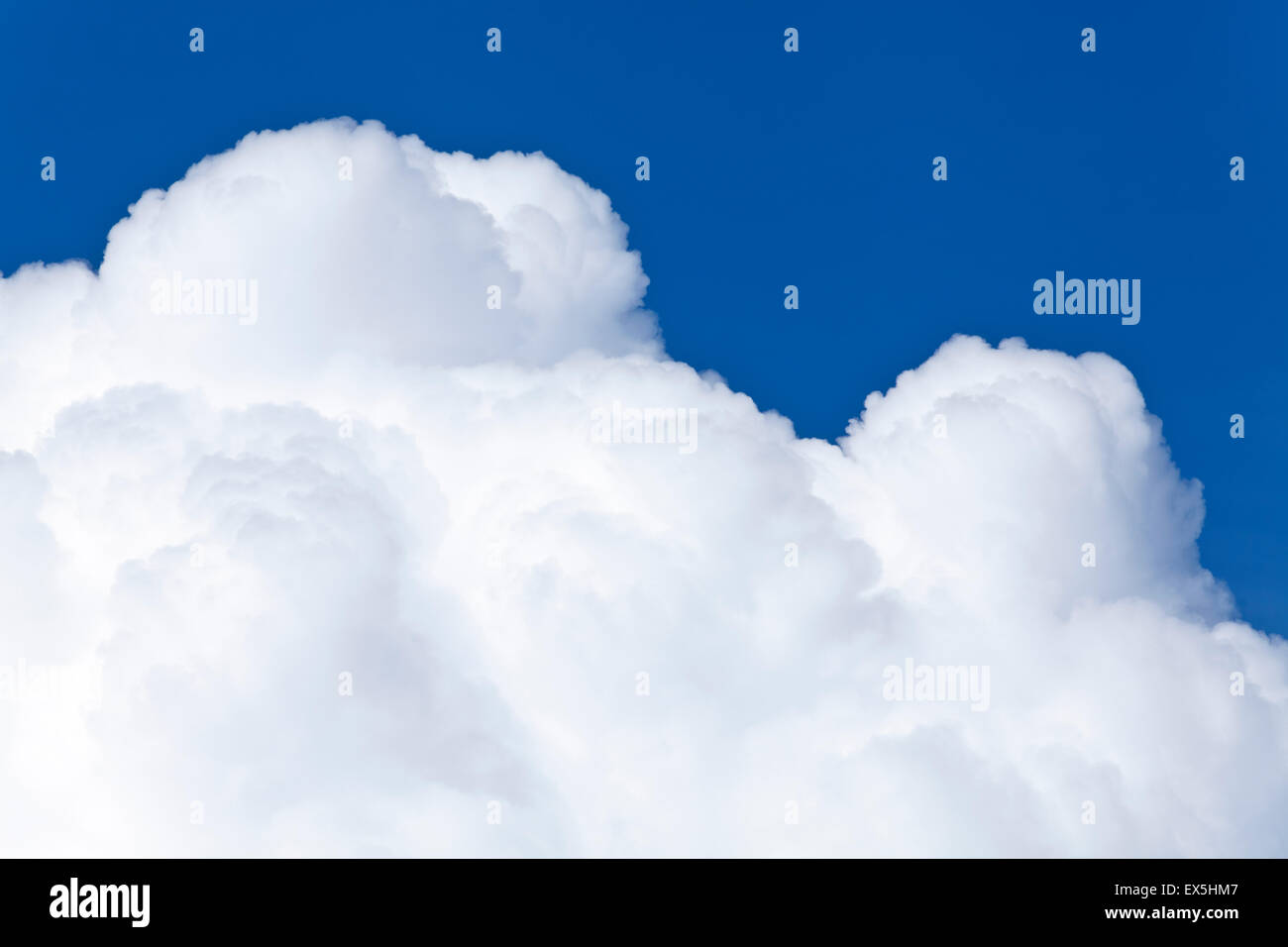 Blue sky and white background with fluffy Cumulus clouds in a distance ...
