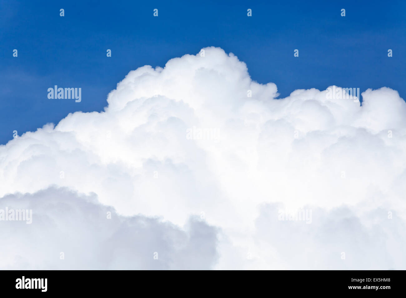 Blue sky and white background with fluffy Cumulus clouds in a distance ...