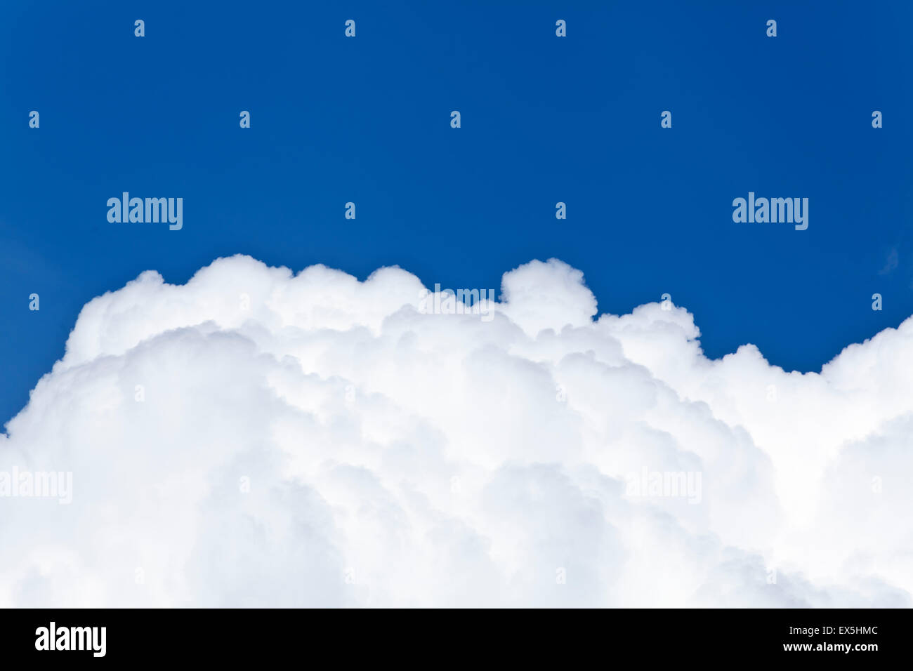 Blue sky and white background with fluffy Cumulus clouds in a distance ...