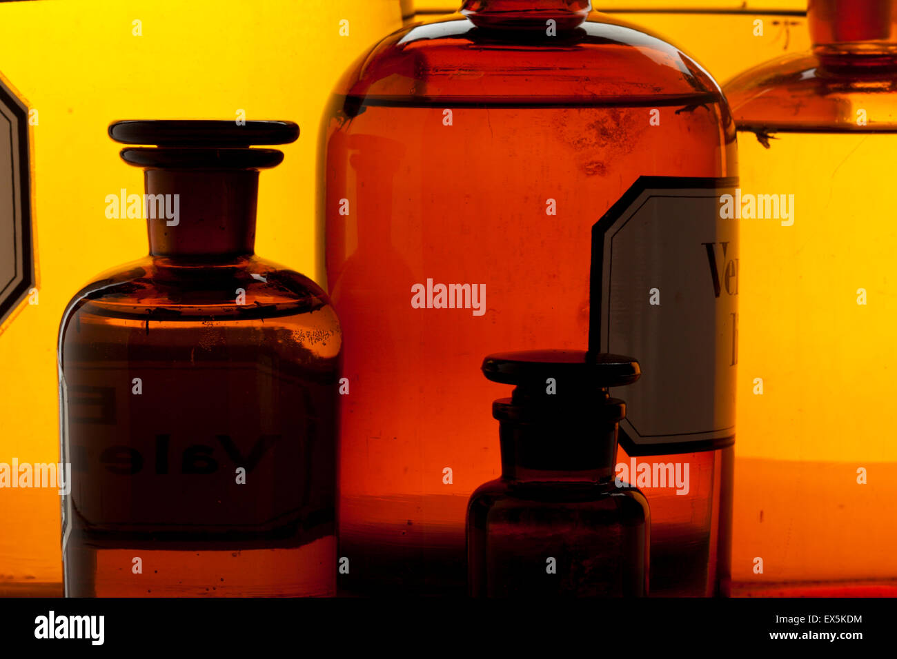 Closeup of vintage apothecary bottles assortment, back lighting Stock Photo