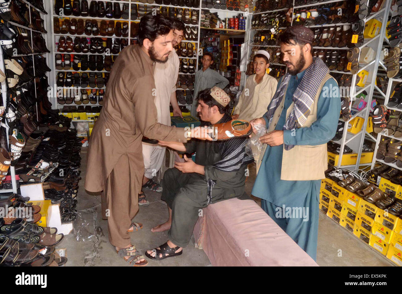 People buying new shoes to wear on Eid Day coming ahead, at shop
