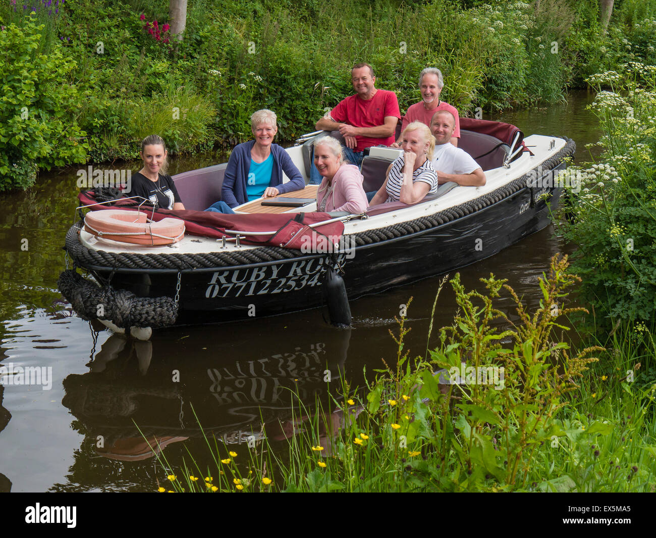 People enjoy a boat trip on the Monmouthshire and Brecon Canal, near Brecon, Powys, Wales, UK Stock Photo
