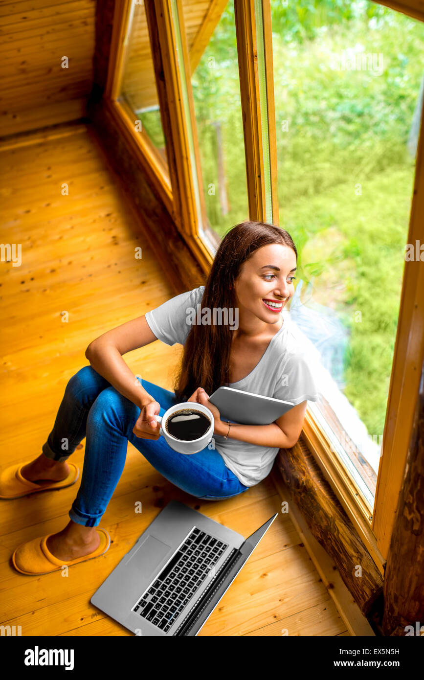 Woman with tablet near the window in cottage Stock Photo