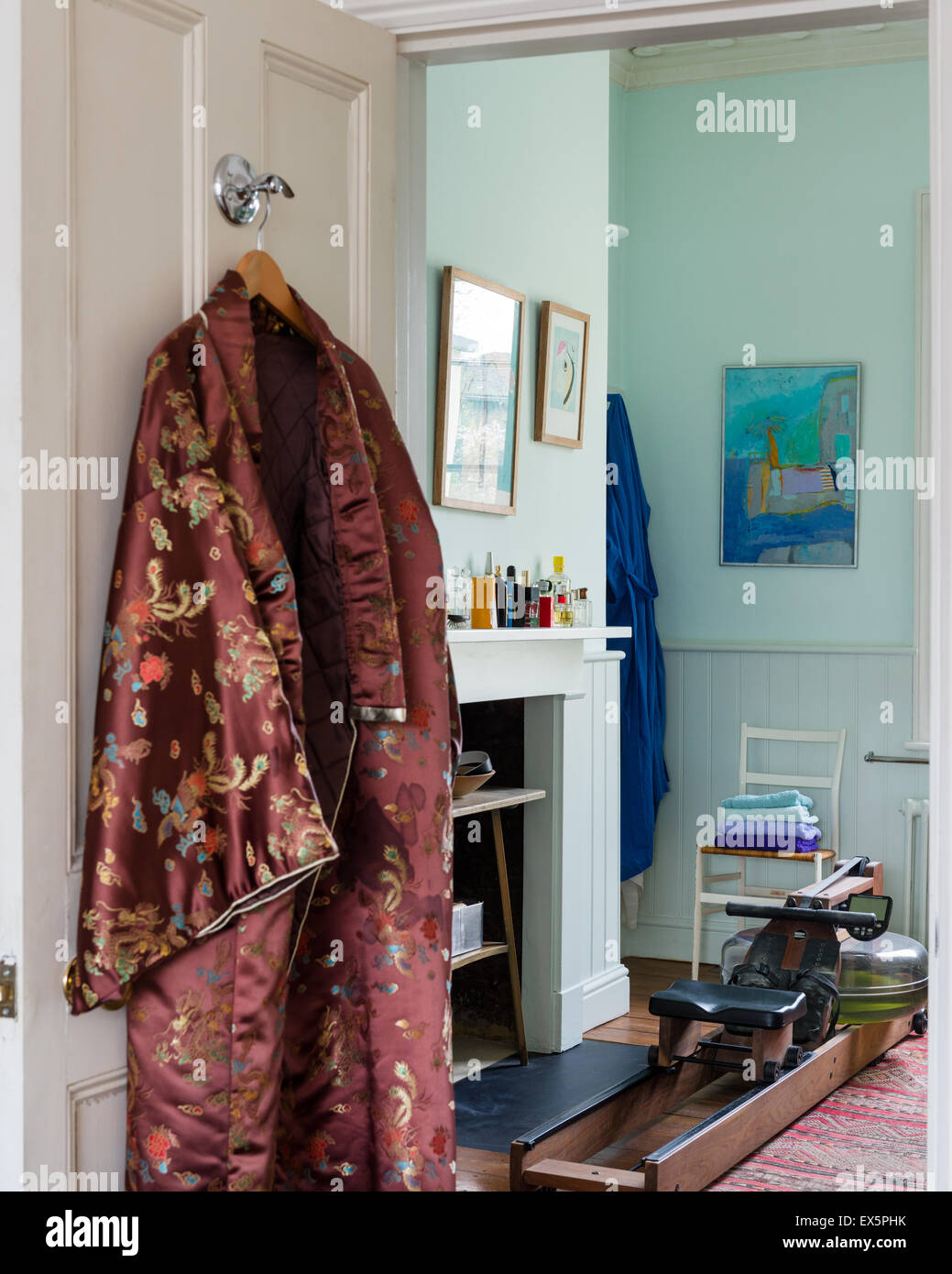 A silk kimono hangs on the back of the bathroom door Stock Photo