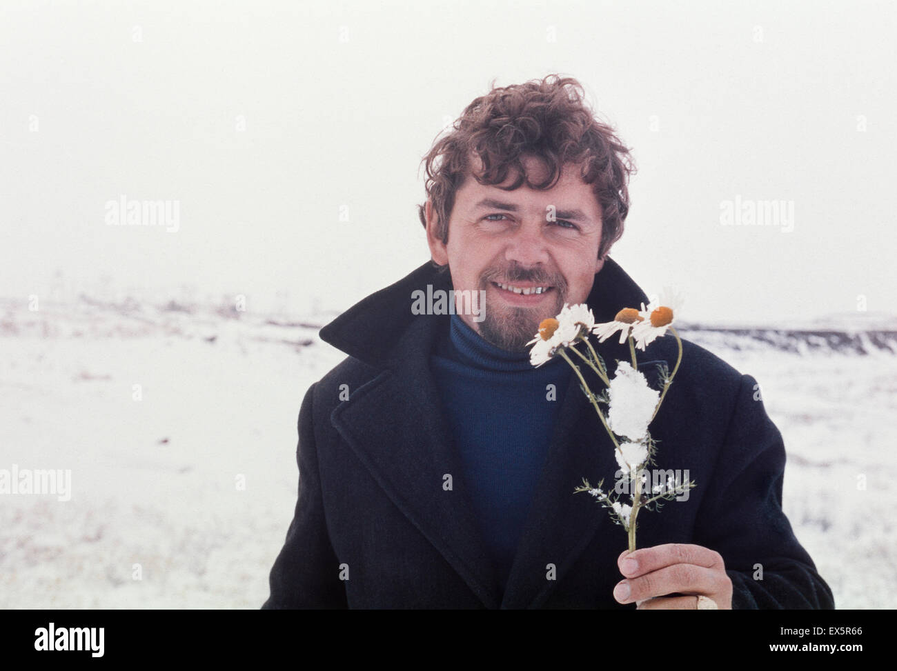 Outdoor vintage portrait of soviet gold-prospector with Oxeye Daisy flower - photo taken in tundra on Chukchi Peninsula, June 19 Stock Photo