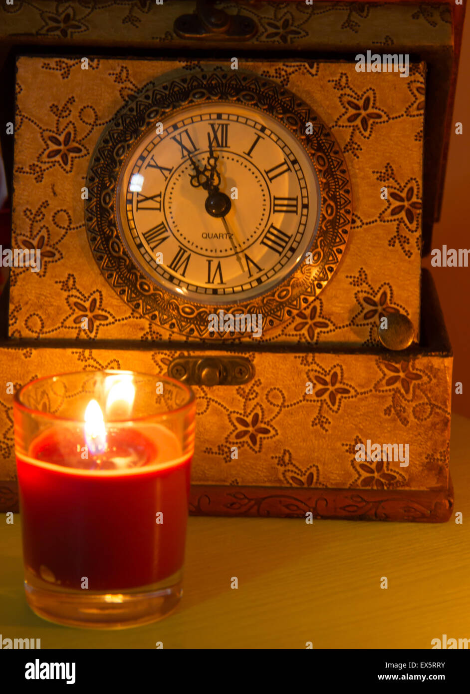 Clock and candle in a dark atmosphere Stock Photo Alamy