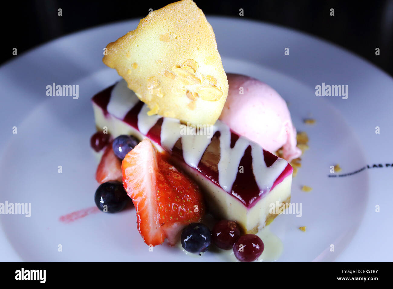 Blueberry cheesecake served with blueberries, strawberry, a waffle and