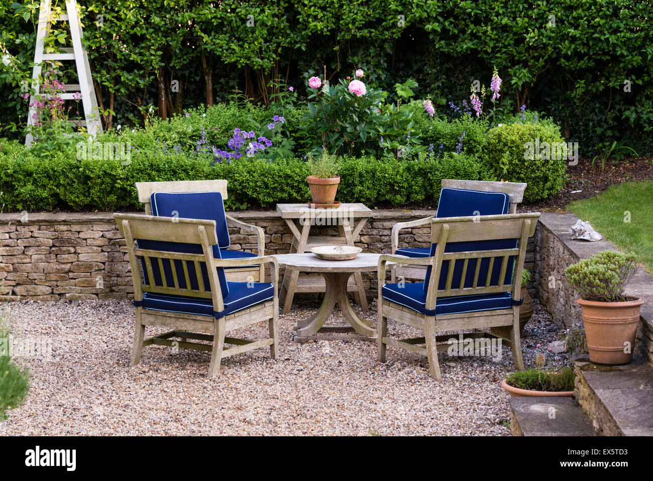 Outdoor wooden furniture in country garden Stock Photo