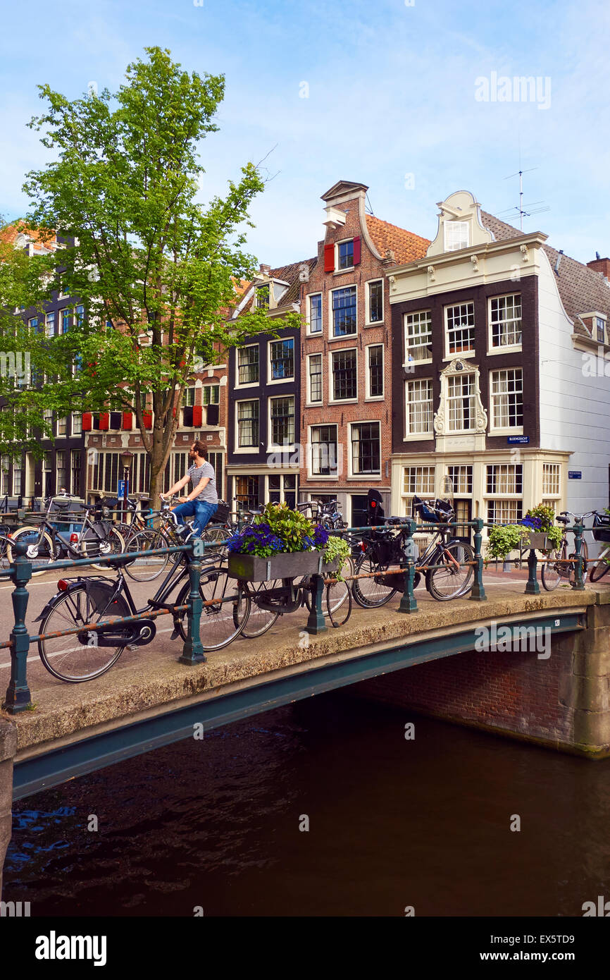 Bicycles parked on a quiet canal bridge in Nine Streets district of Amsterdam, Netherlands, EU. Stock Photo