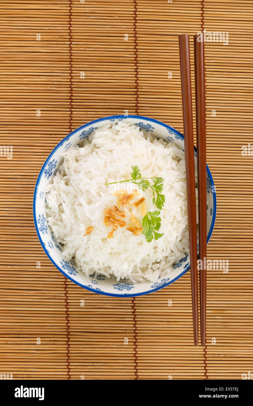 Top view of a bowl of rice with chopsticks Stock Photo