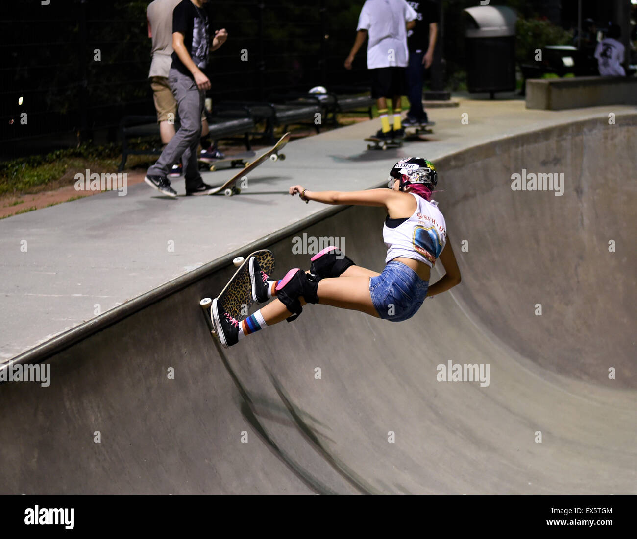 Skaterboarder with pink hair at skate park in Houston Stock Photo