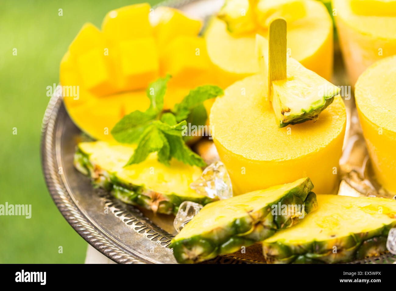 Homemade low calorie popsicles made with mando, pineapple and cocconut