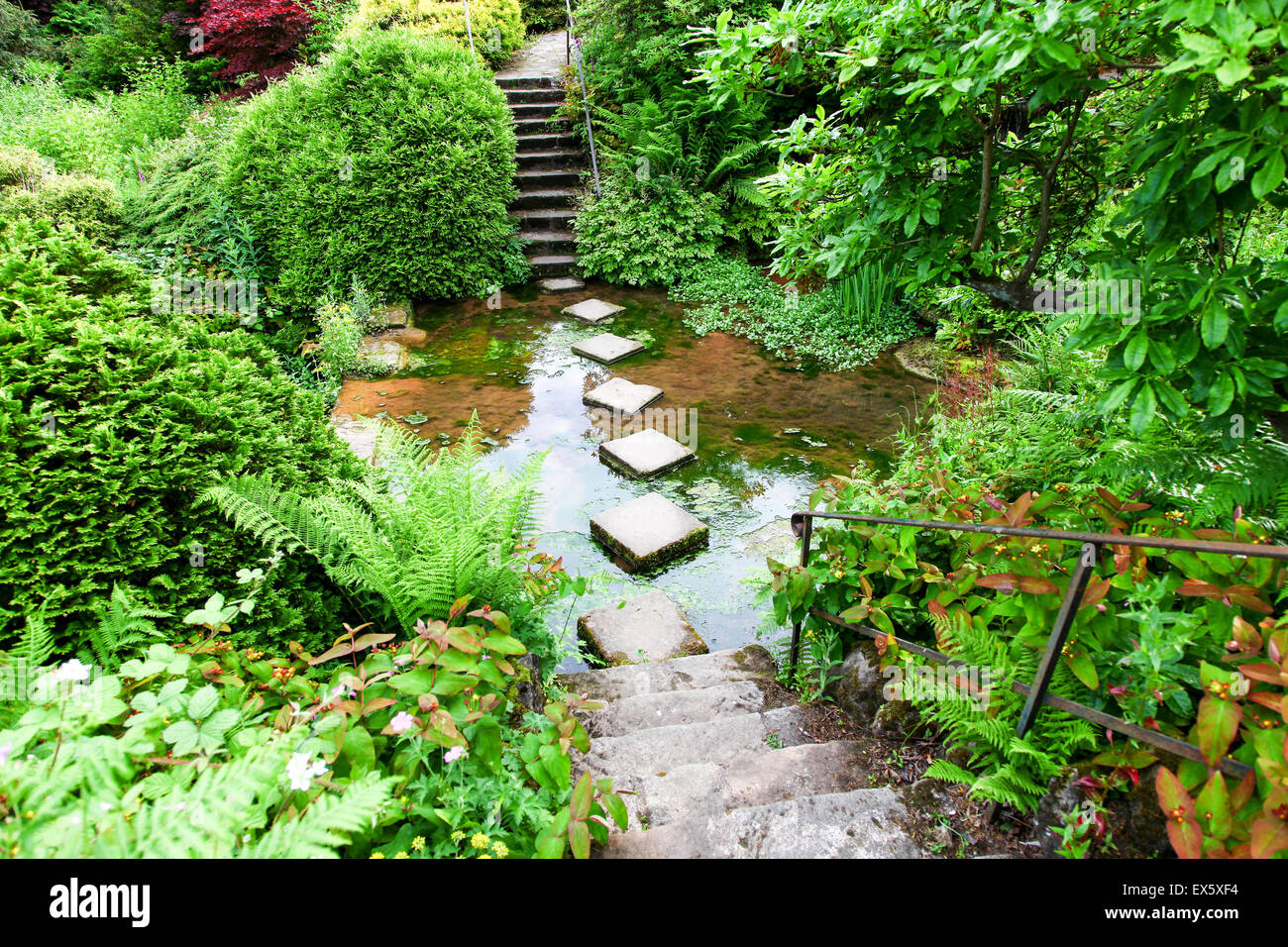Steps and stepping stones leading across a stream at Alton Towers Estate Theme Park Gardens Staffordshire England UK Stock Photo