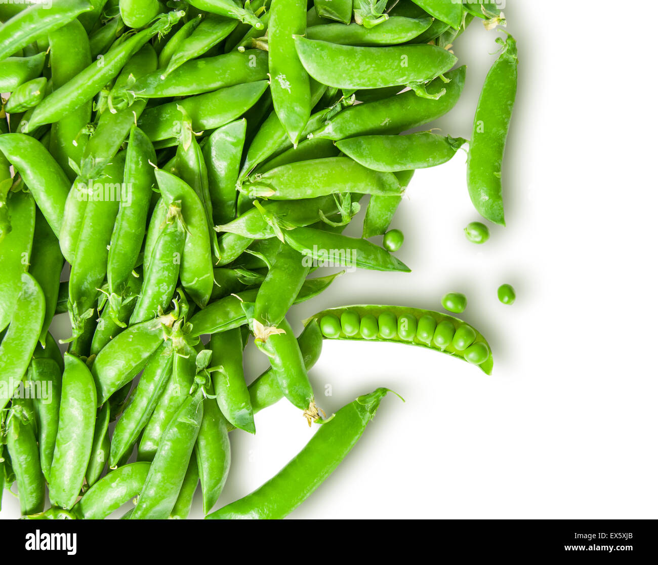 The scattered pods of green peas isolated on white background Stock Photo