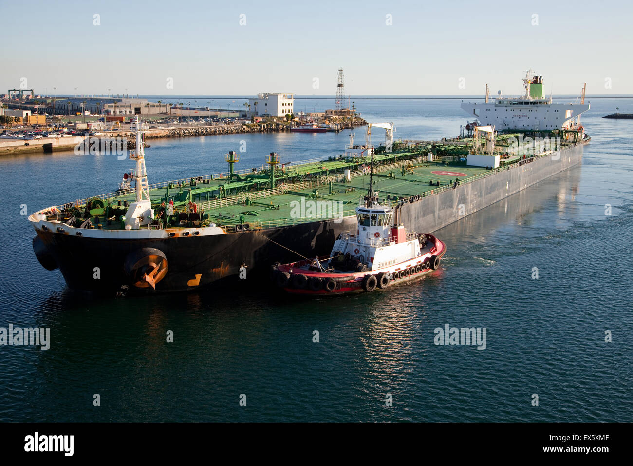 ship and tugboat entering harbor Stock Photo