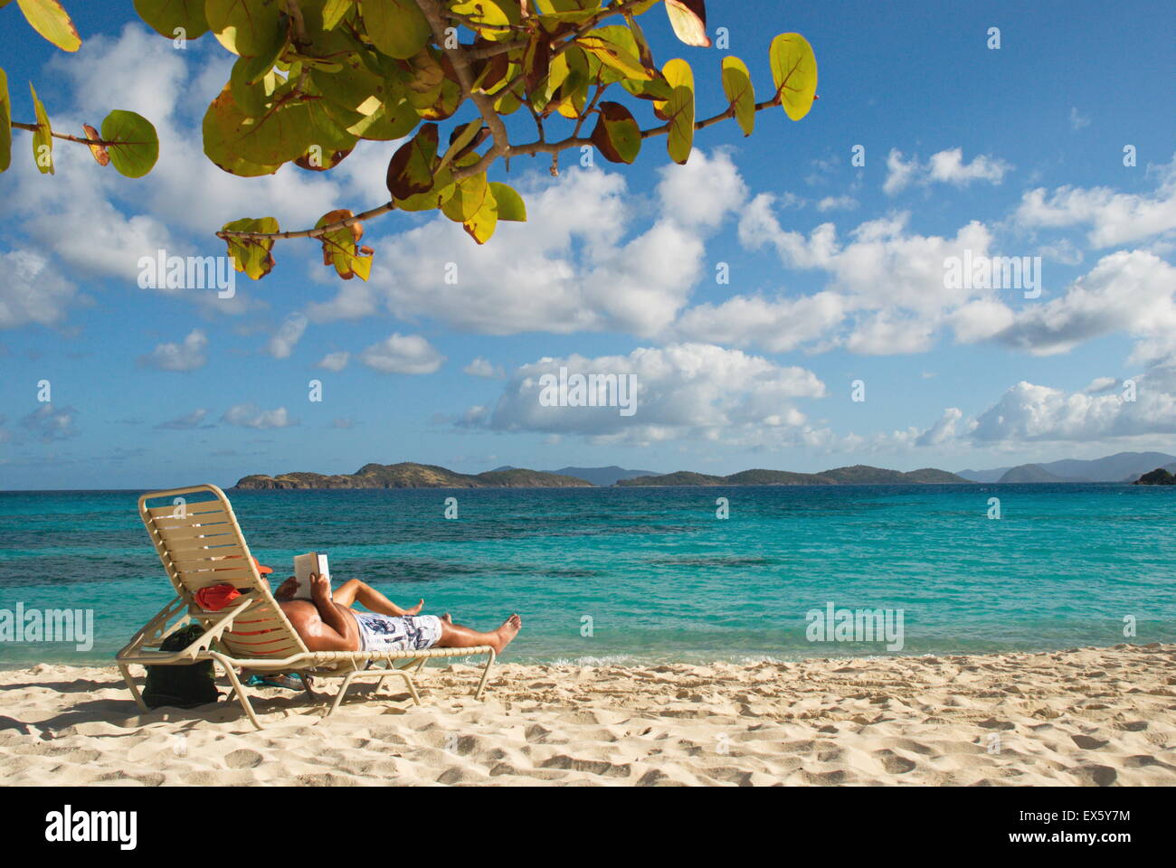 Person laying on beach chair on the island of St. Thomas, US Virgin Islands. Stock Photo