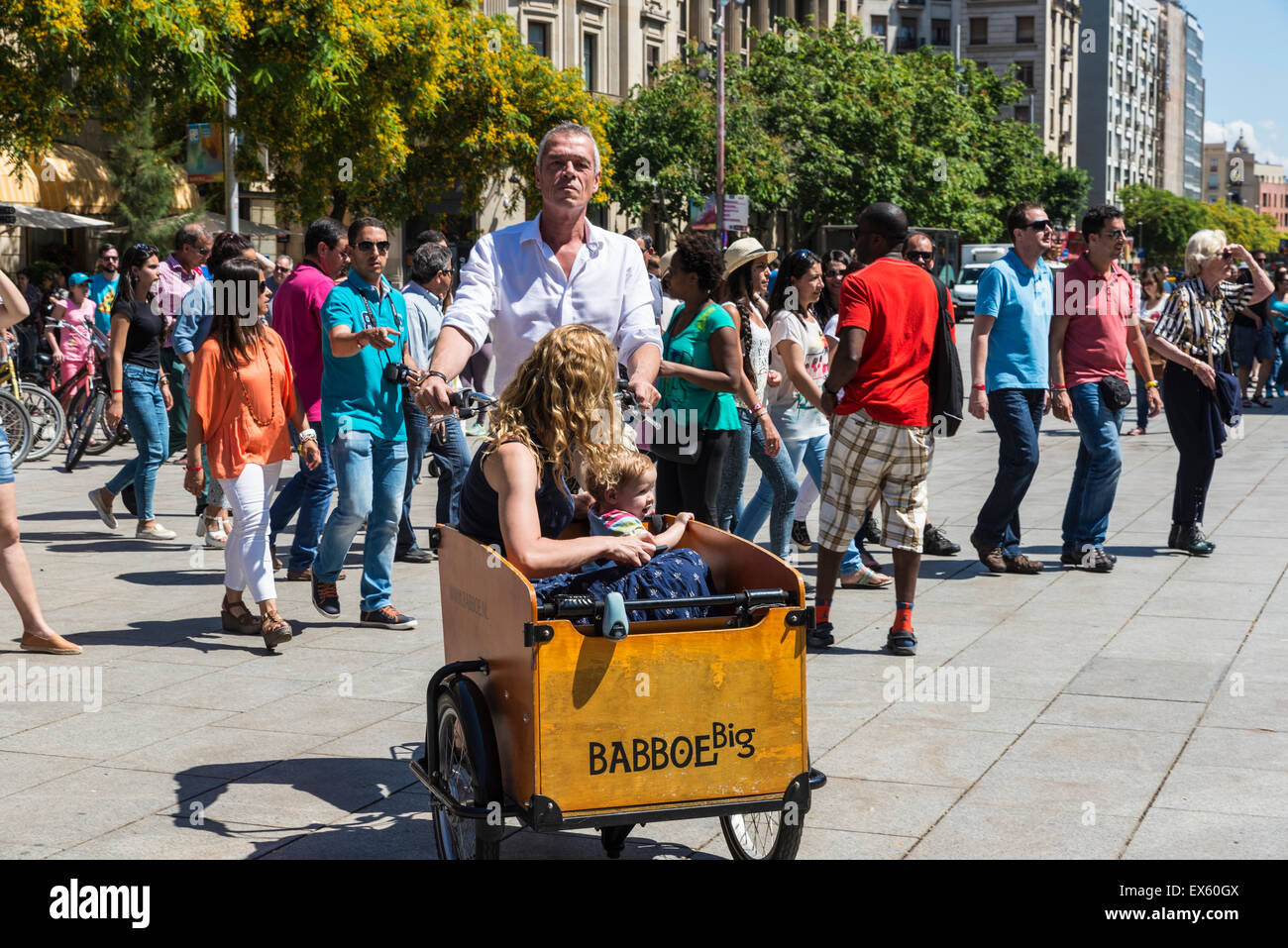 Family circulating on a cargo bike through the old town of Barcelona, Catalonia, Spain Stock Photo