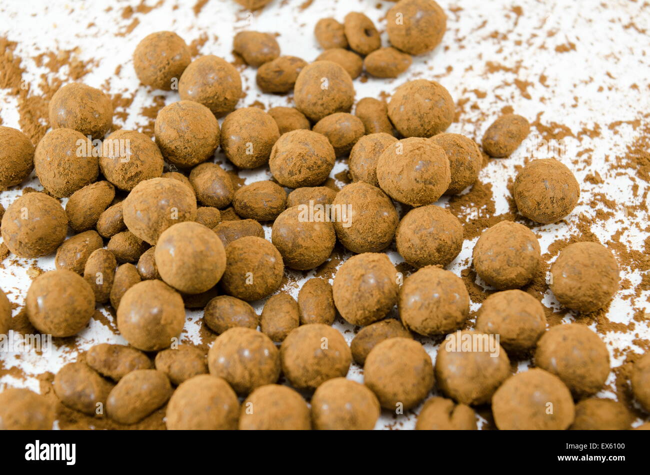 Chocolate balls spread on white table background Stock Photo