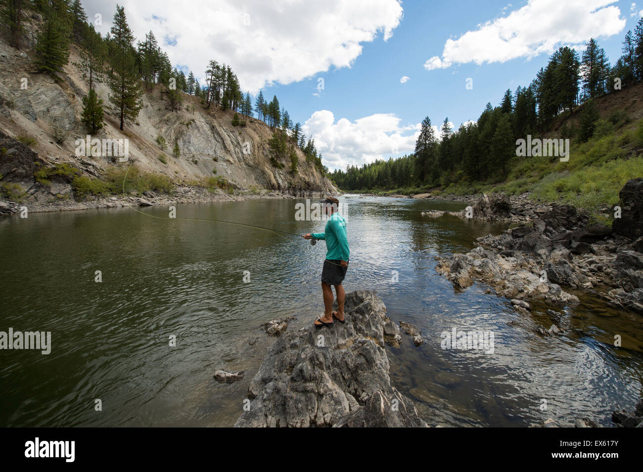 Young flyfisherman casting his rod into a Montana river Stock Photo