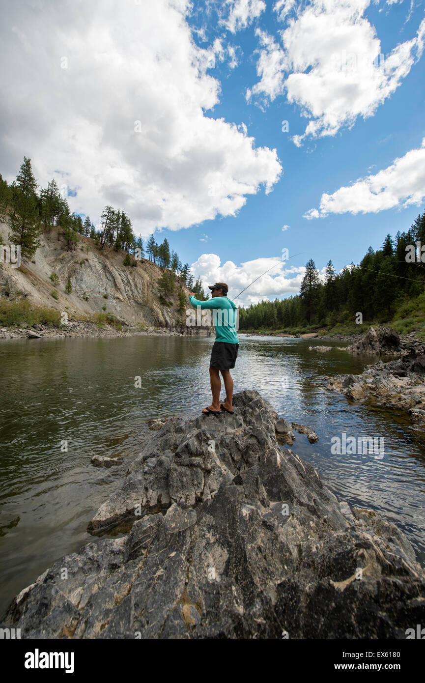 Young flyfisherman casting his rod into a Montana river Stock Photo