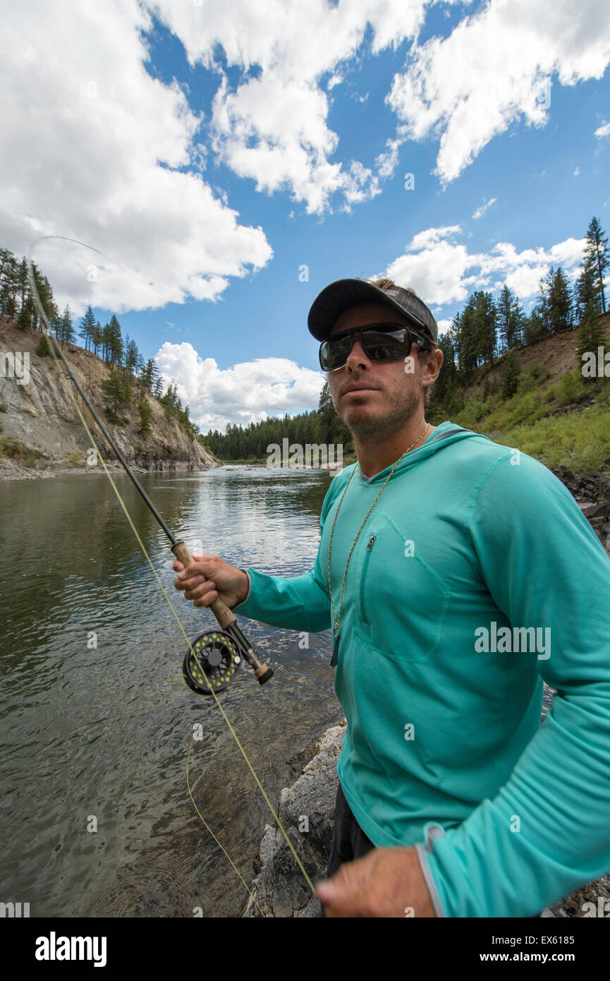 Young flyfisherman casting his rod into a Montana river Stock Photo