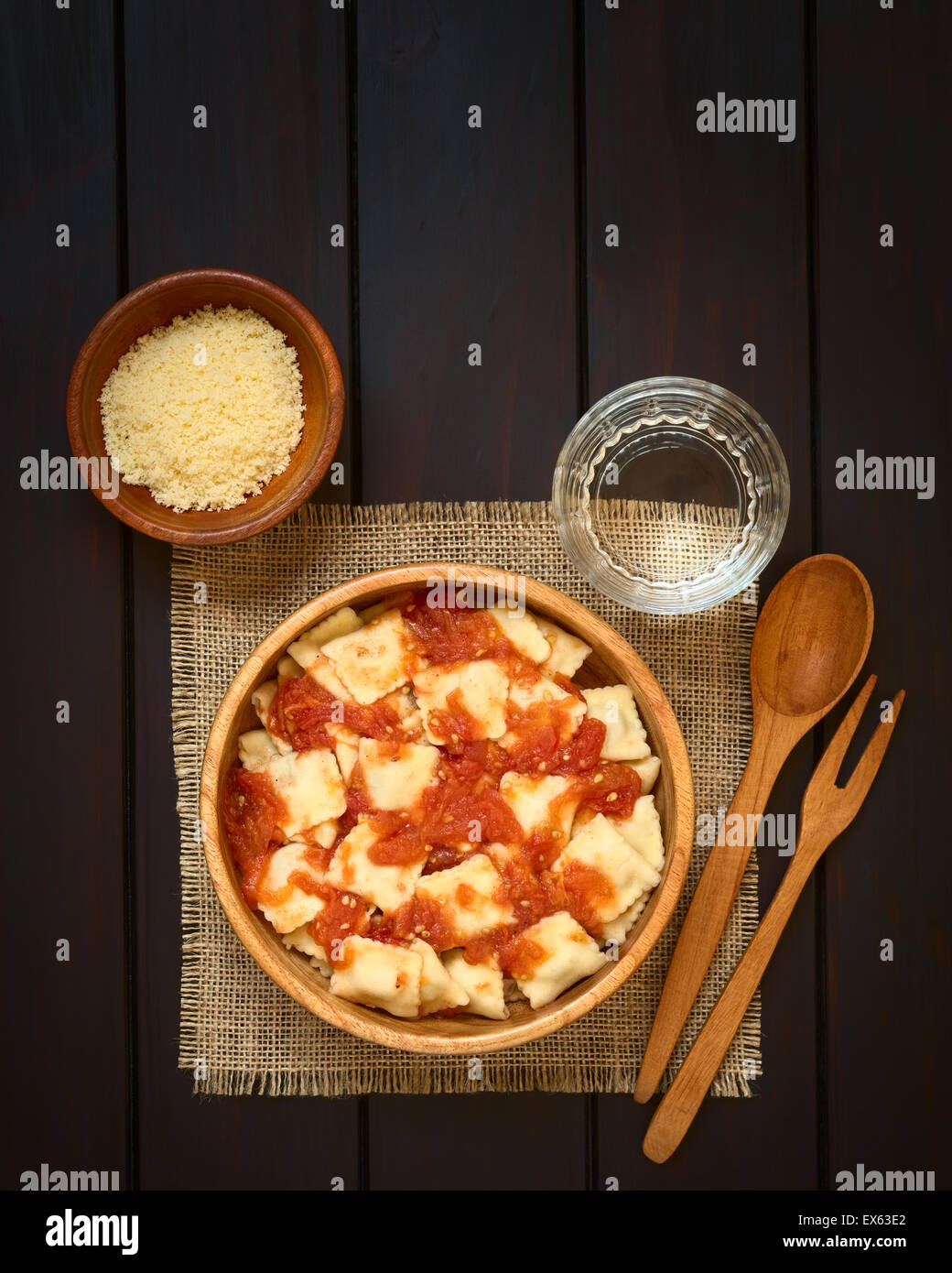 Cooked ravioli with homemade tomato sauce in wooden bowl with grated ...