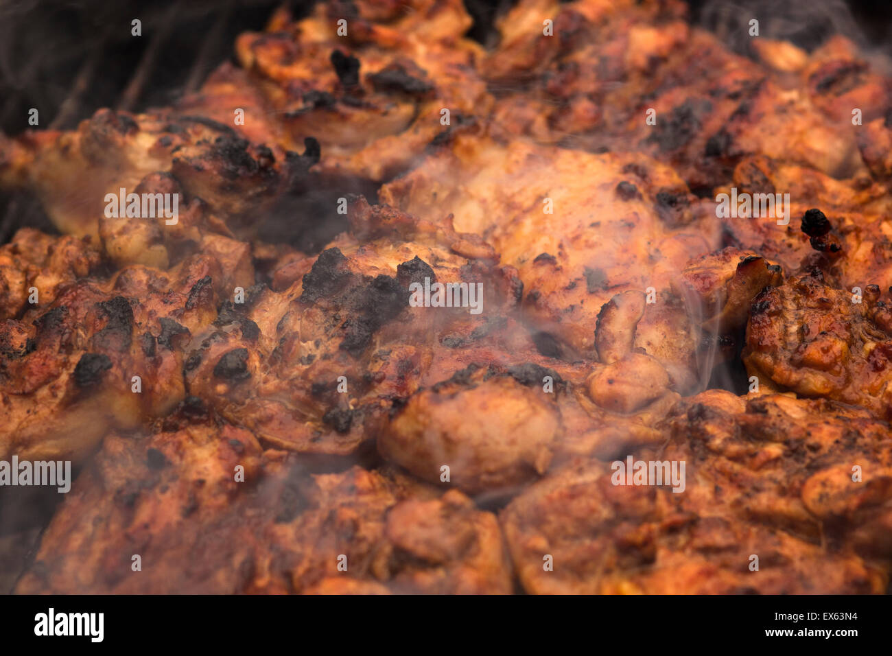 BBQ chicken cooking on a grill. Stock Photo