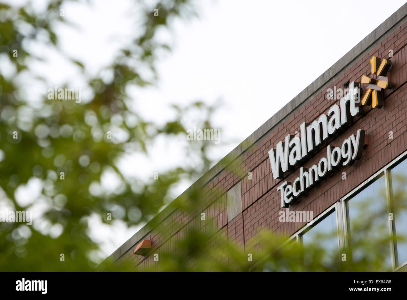 A logo sign outside of an office building occupied by Walmart