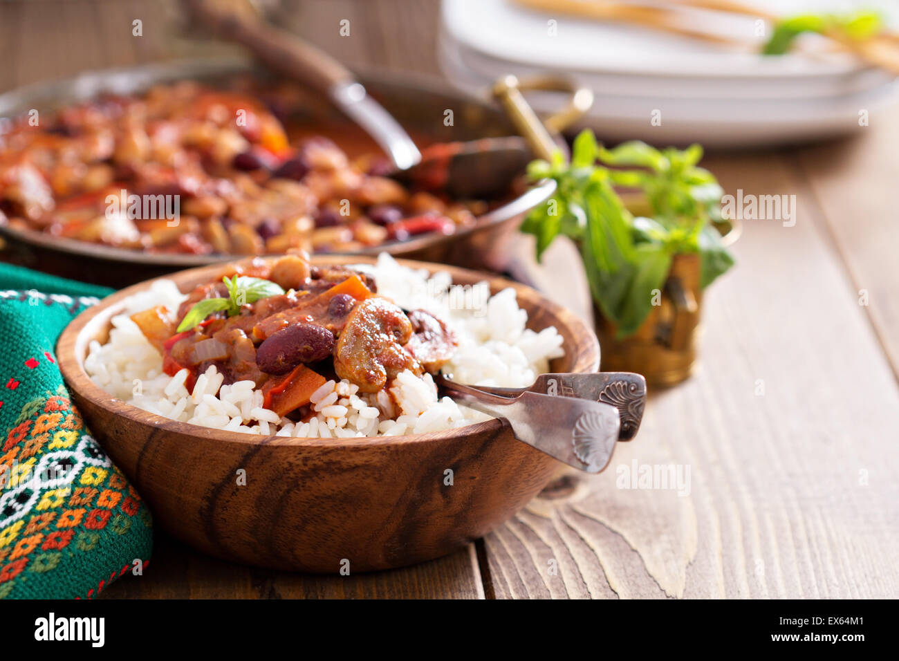 Vegan chili with beans, mushrooms, and vegetables served on rice Stock Photo