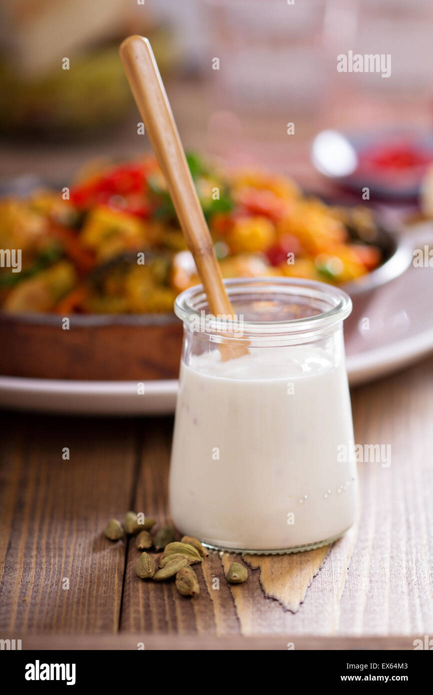 Cardamom non dairy yogurt served with vegetable curry Stock Photo