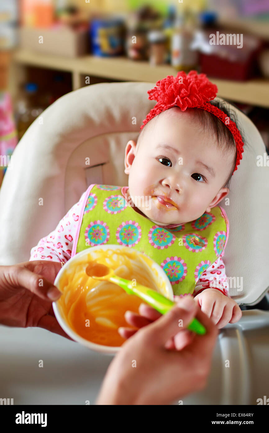 Baby Eating Solid Food Stock Photo